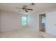 Well-lit bedroom featuring a ceiling fan and window at 4961 Grist Mill Cir, New Port Richey, FL 34655