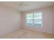 Bedroom with large window and ceiling fan at 4961 Grist Mill Cir, New Port Richey, FL 34655