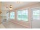 Sunroom with tiled floor, built-in shelving, and large windows at 4961 Grist Mill Cir, New Port Richey, FL 34655