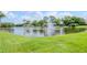 Scenic lake view with fountain and lush landscaping at 4961 Grist Mill Cir, New Port Richey, FL 34655