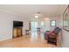 Spacious living room with hardwood floors, a ceiling fan, and comfortable seating at 4961 Grist Mill Cir, New Port Richey, FL 34655