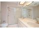 Bathroom with double vanity, shower, and tiled floors at 4961 Grist Mill Cir, New Port Richey, FL 34655