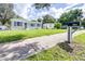 Newly built single-Gathering home with blue shutters and a green lawn at 2102 E Annie St, Tampa, FL 33612