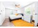 Bright bedroom with ceiling fan, window blinds, and a full bed at 2102 E Annie St, Tampa, FL 33612