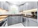 Gray cabinets, stainless steel appliances, and granite countertops at 2102 E Annie St, Tampa, FL 33612