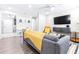 Open living area with gray sofa and hardwood floors at 2102 E Annie St, Tampa, FL 33612