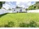 Large grassy backyard with home and fence visible at 2102 E Annie St, Tampa, FL 33612