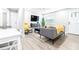 Bright living room with gray sofa and yellow throw at 2102 E Annie St, Tampa, FL 33612