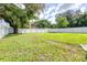 Large backyard with grassy lawn and white fence at 2102 E Annie St, Tampa, FL 33612