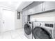 Laundry room with gray cabinets and LG washer and dryer at 2102 E Annie St, Tampa, FL 33612