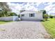 Updated bungalow with a gravel driveway and fenced yard at 2102 E Annie St, Tampa, FL 33612