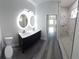 Modern bathroom with double vanity, lighted mirrors, and tiled shower at 3001 E 25Th Ave, Tampa, FL 33605