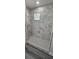 Stunning walk-in shower features stylish marble tiling, a pebble floor, and a window to let light in at 3001 E 25Th Ave, Tampa, FL 33605