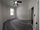 Bedroom with gray vinyl flooring, window, and mirrored closet at 3001 E 25Th Ave, Tampa, FL 33605