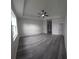 Large primary bedroom with tray ceilings, gray wood floors, ample space, and abundant natural light at 3001 E 25Th Ave, Tampa, FL 33605