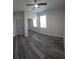 Cozy bedroom with wood-look floors, closet with mirrored doors, and ceiling fan at 3001 E 25Th Ave, Tampa, FL 33605