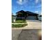 Beautiful single-story home featuring a modern design and a spacious driveway at 3001 E 25Th Ave, Tampa, FL 33605