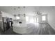 Modern kitchen boasts white cabinetry, stainless steel appliances, and a stylish center island with quartz countertop at 3001 E 25Th Ave, Tampa, FL 33605