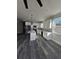 Modern kitchen boasts white cabinetry, stainless steel appliances, and a stylish center island with quartz countertop at 3001 E 25Th Ave, Tampa, FL 33605