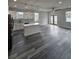 Modern kitchen boasts white cabinetry, stainless steel appliances, and a stylish center island with quartz countertop at 3001 E 25Th Ave, Tampa, FL 33605