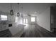 Open concept living room and kitchen with modern lighting and patio doors at 3001 E 25Th Ave, Tampa, FL 33605