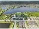Beautiful aerial view of a lakeside community with lush greenery, a park and walking trails surrounding the lake at 6357 Shore Vista Pl, Apollo Beach, FL 33572
