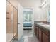 Bathroom with glass shower, double vanity, and doorway to bedroom at 6357 Shore Vista Pl, Apollo Beach, FL 33572