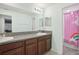 Bathroom with double vanity, gray countertop, and pink unicorn shower curtain at 6357 Shore Vista Pl, Apollo Beach, FL 33572