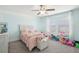Bedroom with pink bedding, white furniture, and two windows at 6357 Shore Vista Pl, Apollo Beach, FL 33572