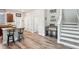 Open kitchen area featuring wood floors, breakfast bar and access to staircase at 6357 Shore Vista Pl, Apollo Beach, FL 33572