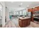Open-concept kitchen with an island, granite countertops, stainless steel appliances, and adjoining living area at 6357 Shore Vista Pl, Apollo Beach, FL 33572