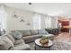 Bright living room with a large sectional, wood floors and natural light at 6357 Shore Vista Pl, Apollo Beach, FL 33572