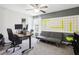 Office with gray sofa, desk with computer setup, and a large graphic wall art at 6357 Shore Vista Pl, Apollo Beach, FL 33572