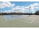 Well-maintained tennis court with an overhead trellis for shade and ample lighting at 6357 Shore Vista Pl, Apollo Beach, FL 33572