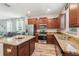 Modern kitchen with granite countertops and stainless steel appliances at 6357 Shore Vista Pl, Apollo Beach, FL 33572