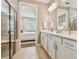 Double vanity bathroom with a walk-in shower and a soaking tub at 9210 Ballaster Pointe Loop, Parrish, FL 34219