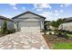 Modern home with a brick paver driveway and landscaping at 9210 Ballaster Pointe Loop, Parrish, FL 34219