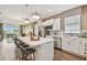 Modern kitchen with white cabinets, an island, and stainless appliances at 9210 Ballaster Pointe Loop, Parrish, FL 34219
