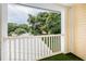 Private balcony offering scenic views of lush trees and neighborhood at 903 Woodbridge Ct, Safety Harbor, FL 34695