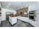 Modern kitchen with white cabinets, stainless steel appliances, and a kitchen island at 903 Woodbridge Ct, Safety Harbor, FL 34695