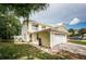 Two-story townhome with a paved driveway and lush landscaping at 903 Woodbridge Ct, Safety Harbor, FL 34695