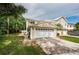 Two-story home with a two-car garage and landscaped yard at 903 Woodbridge Ct, Safety Harbor, FL 34695