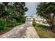 Two-story townhome with a paved driveway and lush landscaping at 903 Woodbridge Ct, Safety Harbor, FL 34695