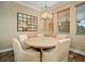 Bright dining area with a round table and four chairs, a chandelier, and a large mirror at 6002 Printery St # 103, Tampa, FL 33616