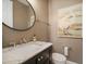 Elegant powder room with marble vanity and bird artwork at 6002 Printery St # 103, Tampa, FL 33616