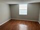 Simple bedroom with wood-look flooring and a window at 811 Russell Ln # 309, Brandon, FL 33510