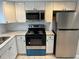 Updated kitchen featuring stainless steel appliances and granite countertops at 811 Russell Ln # 309, Brandon, FL 33510