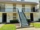 Exterior view of two-story building with stairs and balconies at 811 Russell Ln # 309, Brandon, FL 33510