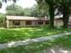 Ranch-style brick home with a large yard and driveway at 803 Bills Cir, Brandon, FL 33511
