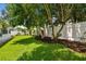 Lush backyard featuring green grass, trees and privacy fence at 1130 Big Creek Dr, Wesley Chapel, FL 33544